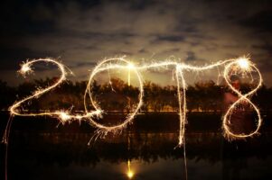 The year "2018" is written on the skyline in trails of fireworks.